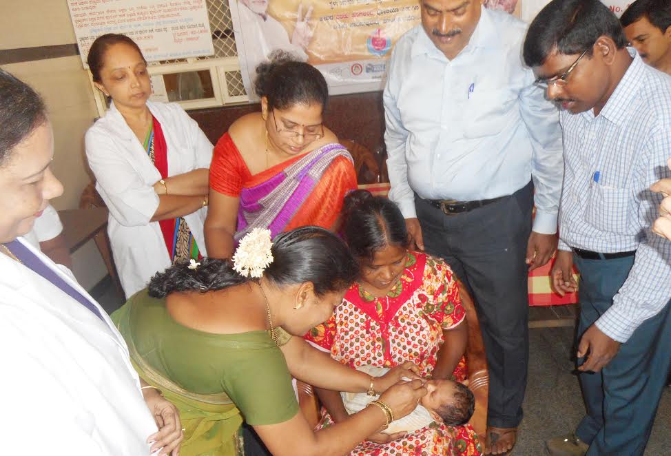 CMC President administers by pulse polio immunization drops to child at Udupi